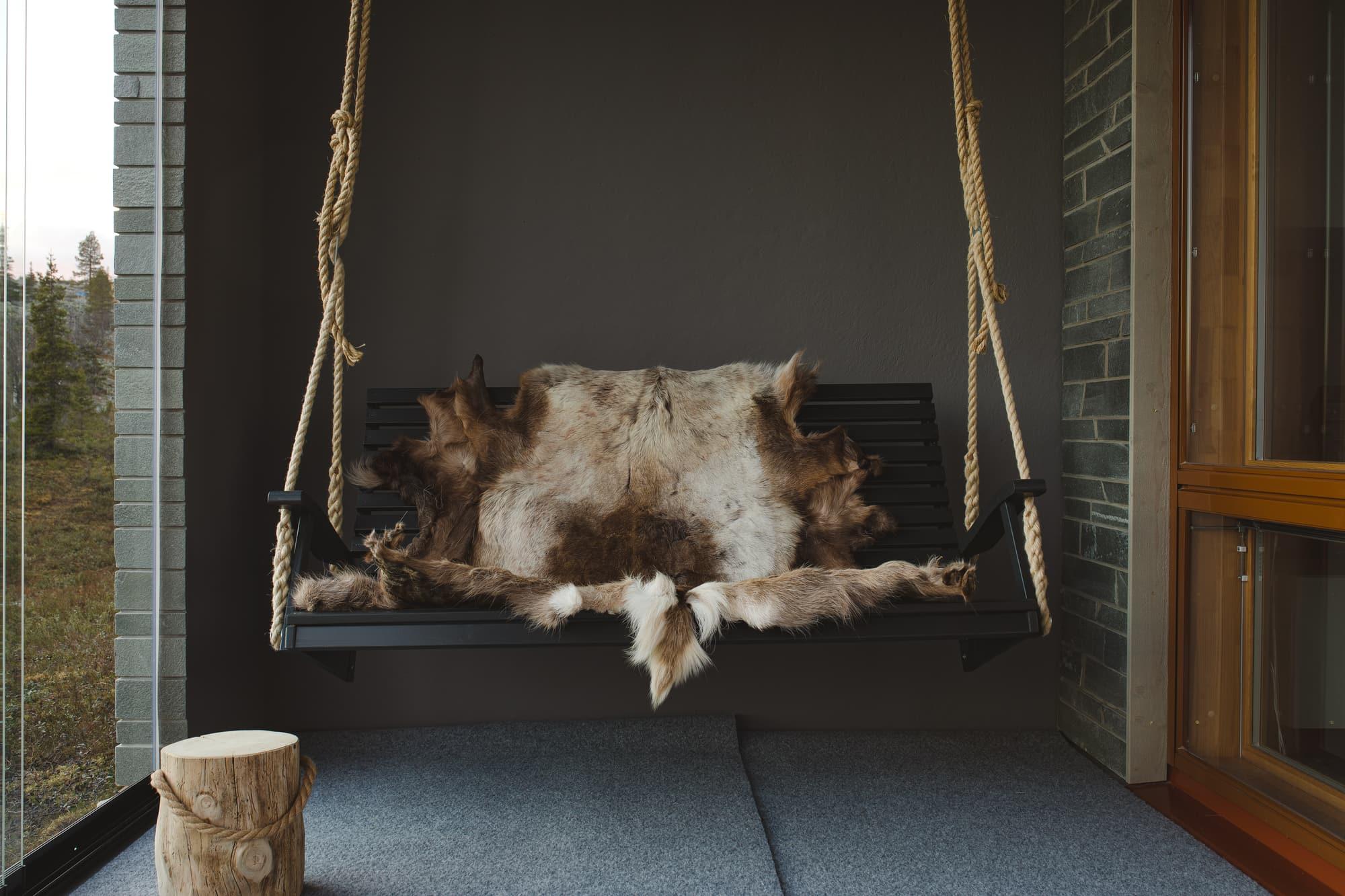 Hanging chair on the glazed terrace