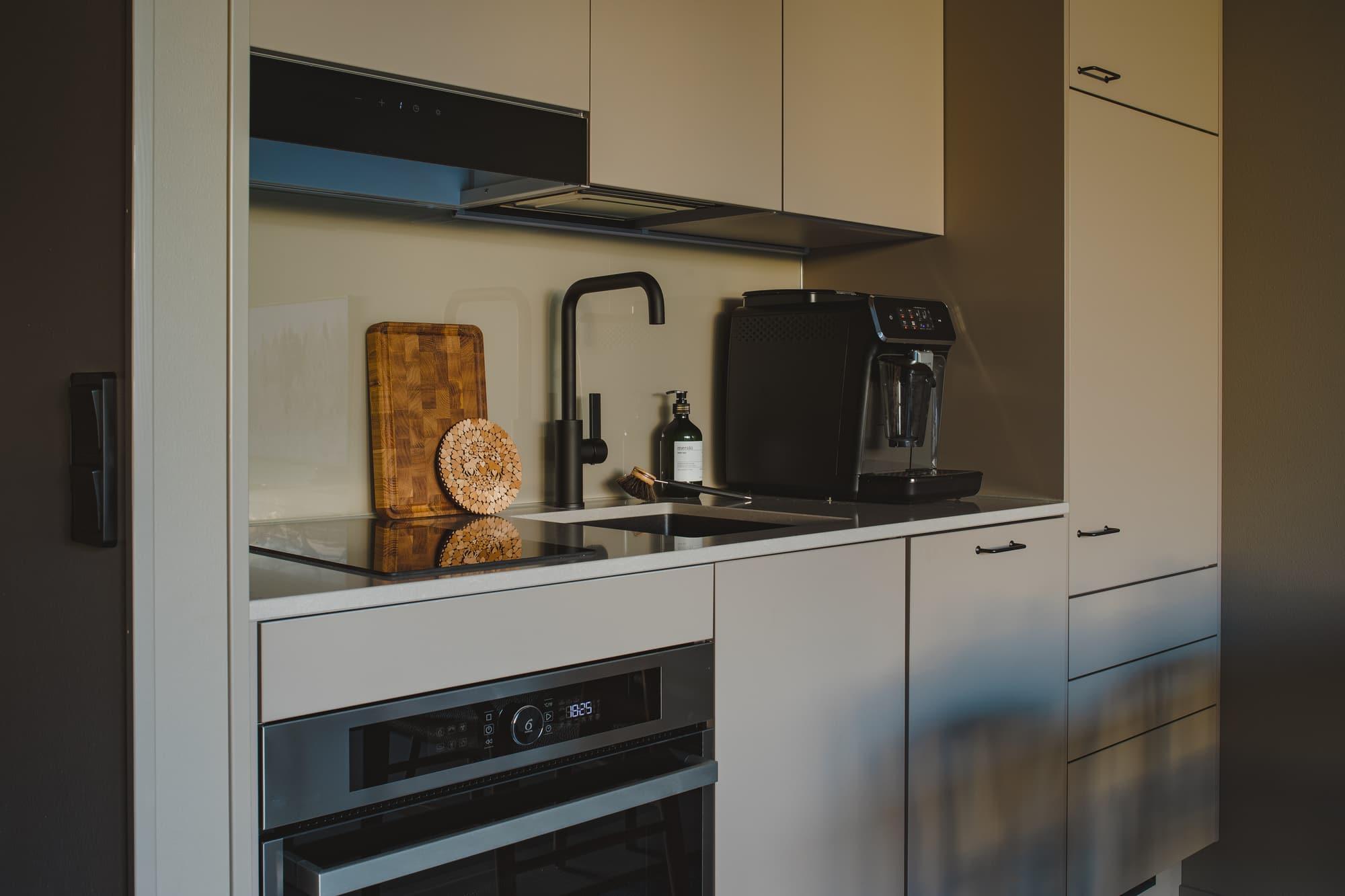 Kitchen with coffee machine and oven