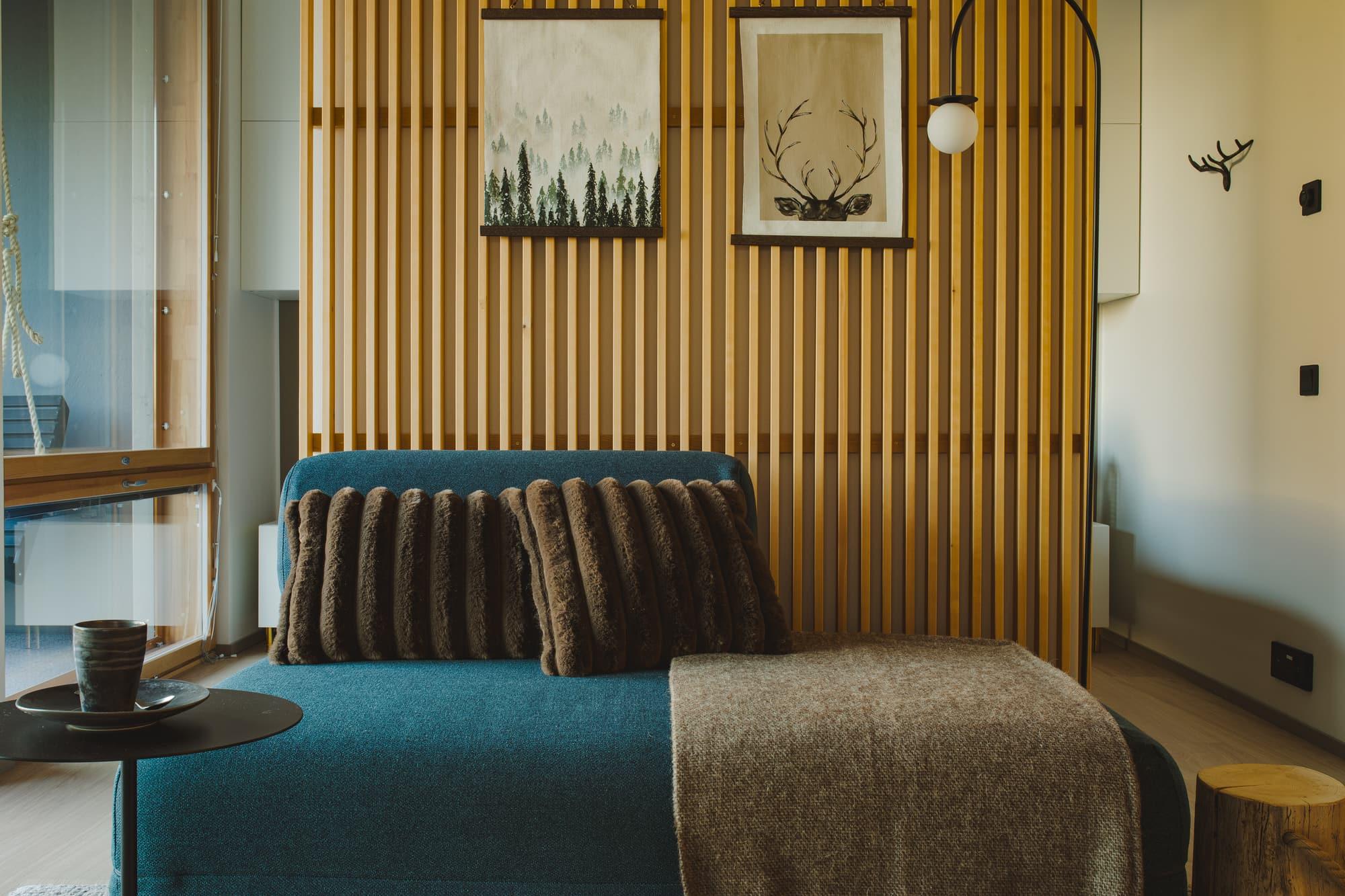 Sofa in front of the timber wall