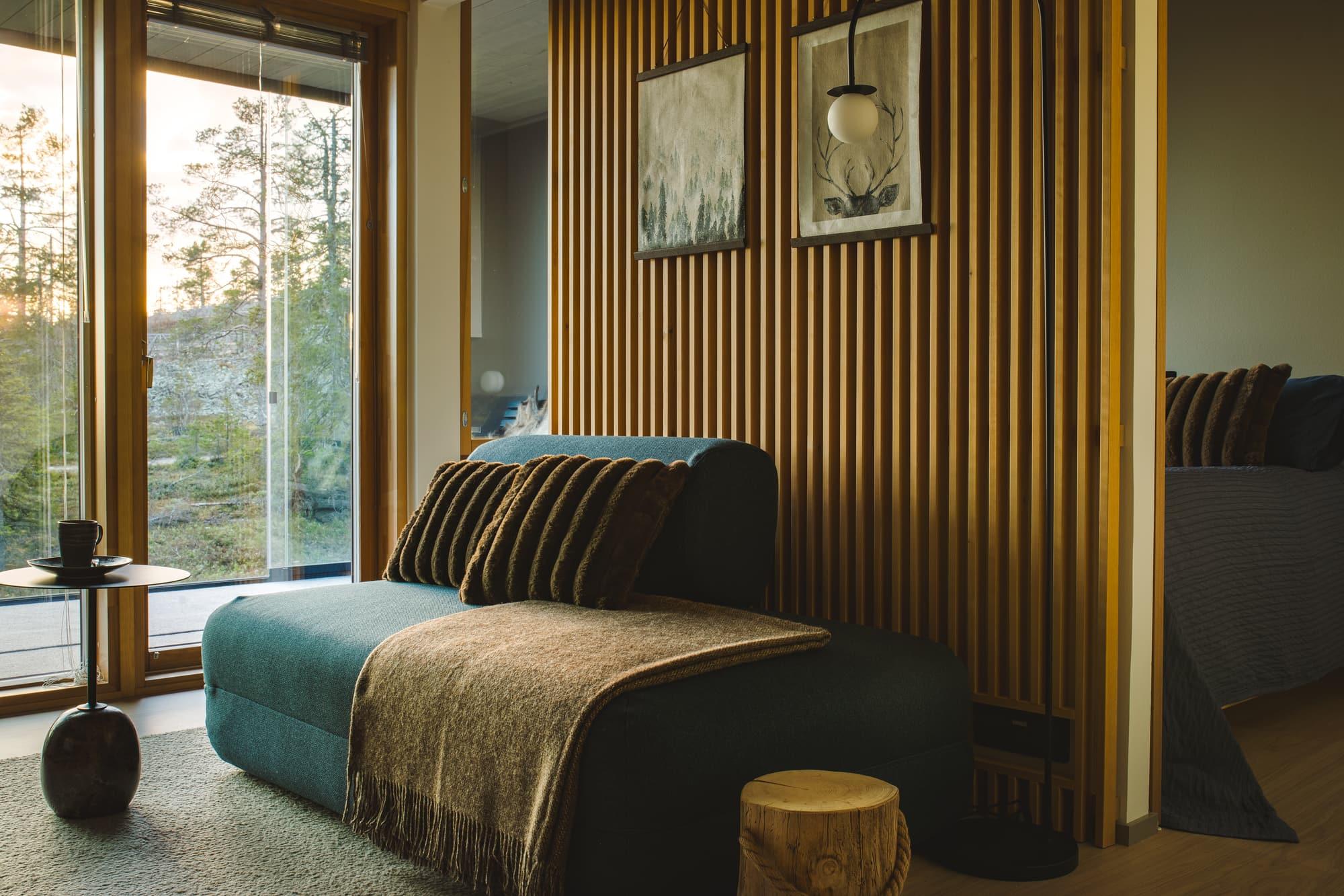 Living room with sofa, timber wall and evening light