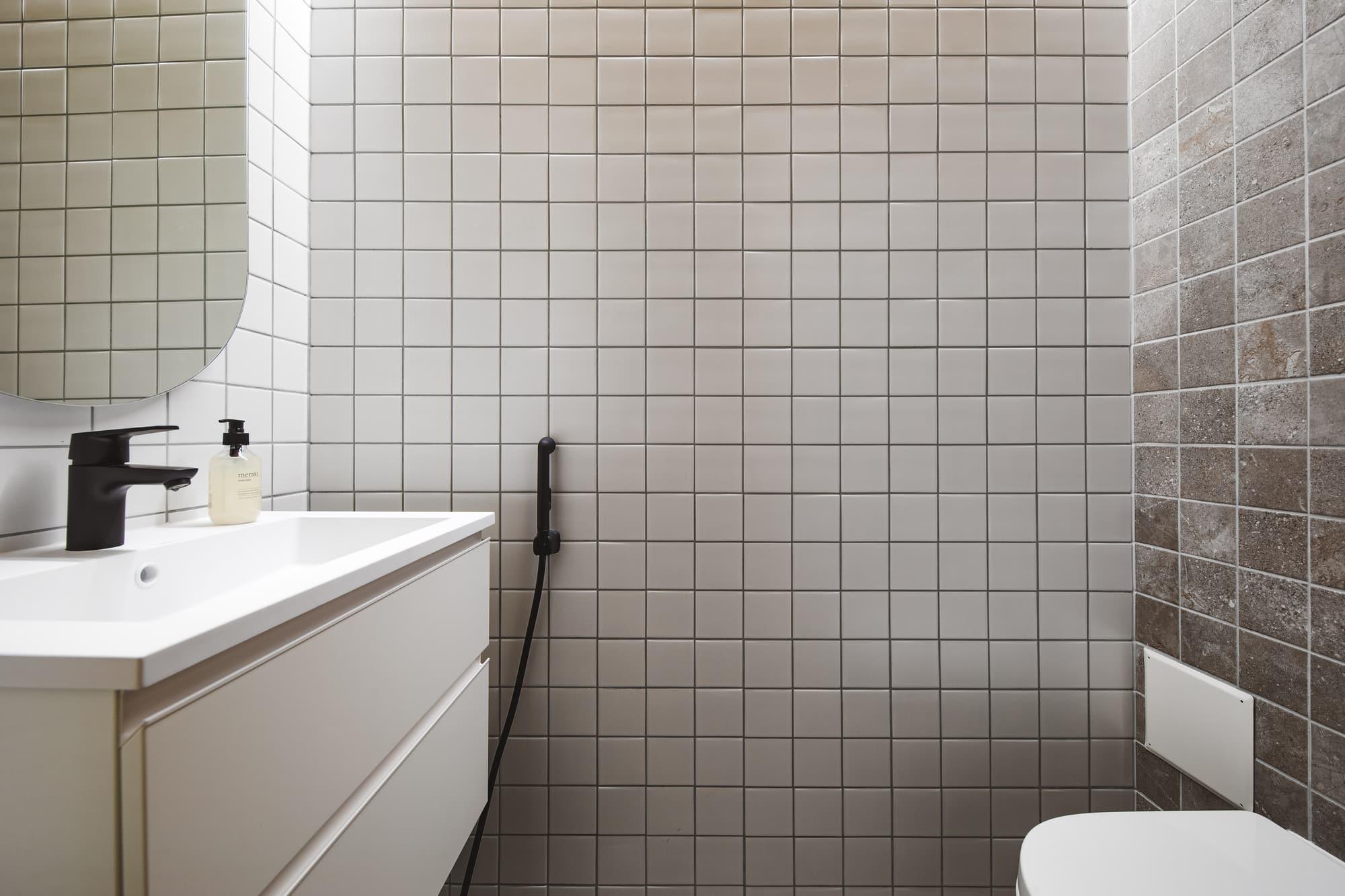 Bathroom with shower and white tiles